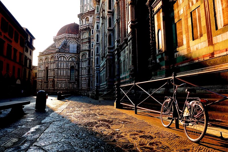Bicycle Near Cathedral — Brown, Dramatic