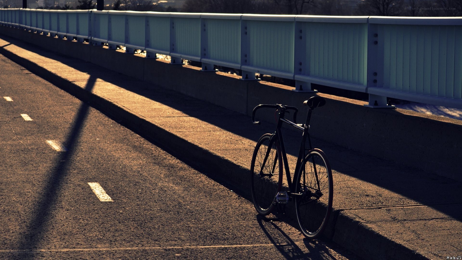 Bicycle on a bridge at sunset
