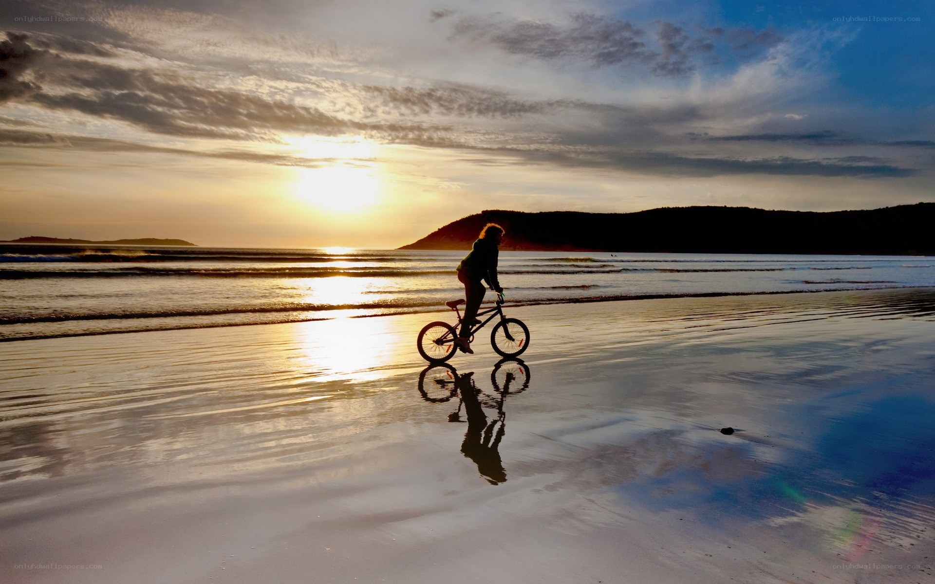 Bicycle on beach at sunset