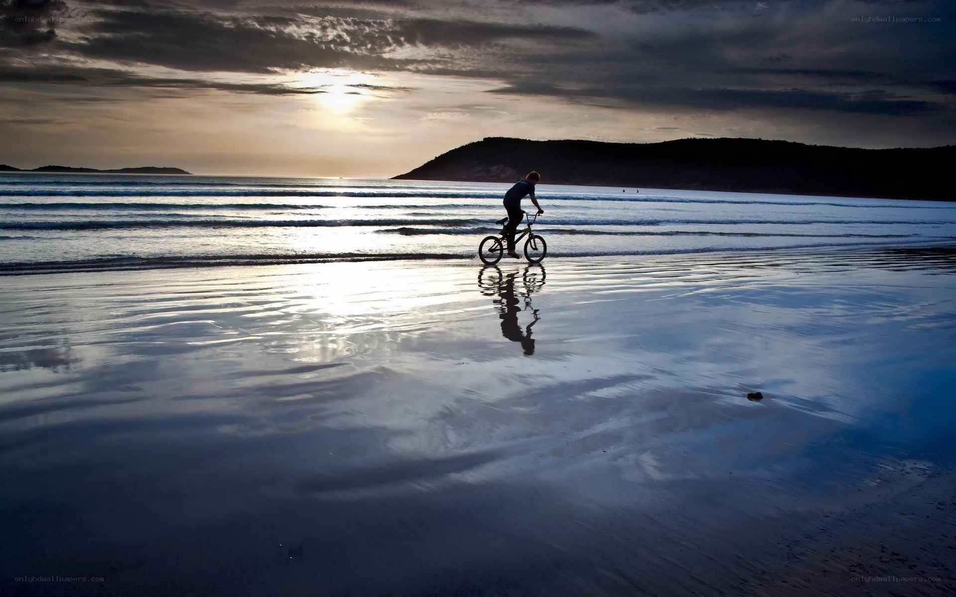 Bicycle on the beach at sunset