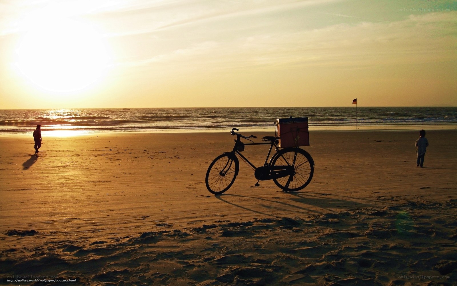 Bicycle on the beach at sunset