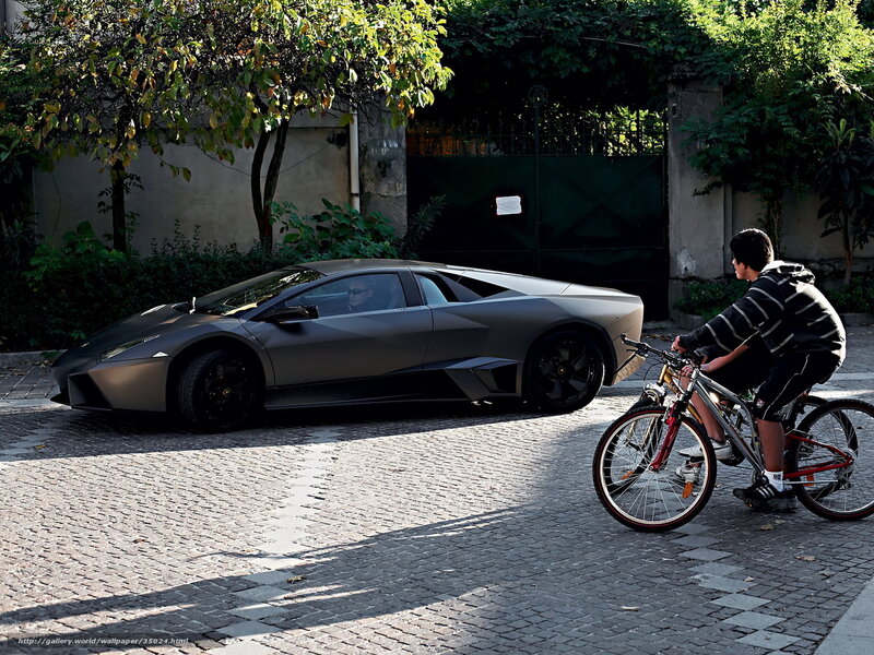 Bicycle rider near supercar