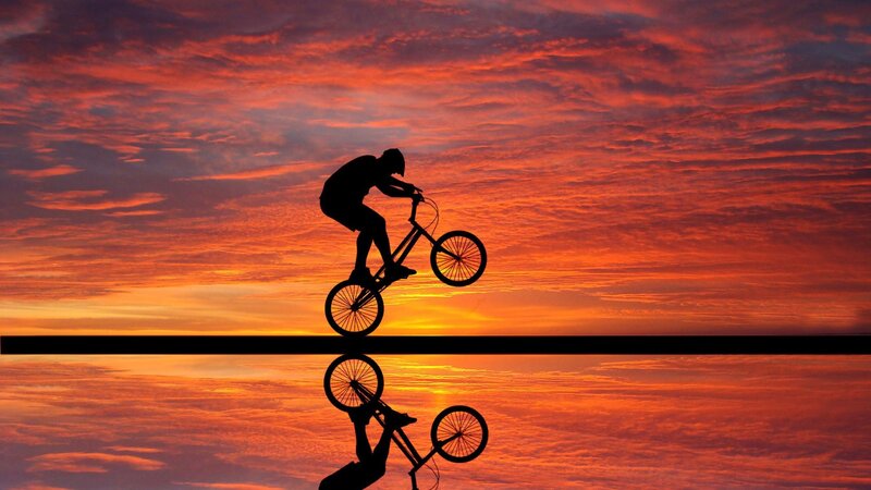 Bicycle Rider Silhouette — Orange