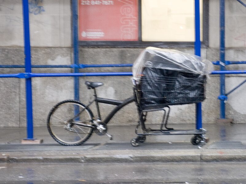 Bicycle with shopping cart on sidewalk