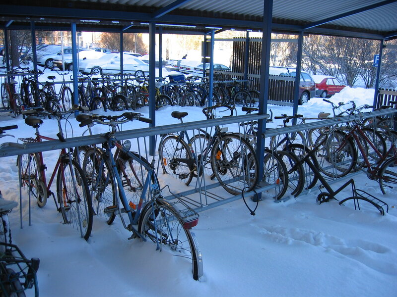 Bicycles in a snowy bike rack