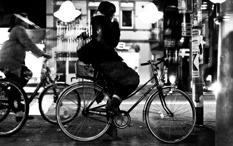 Bicyclists on a city street at night