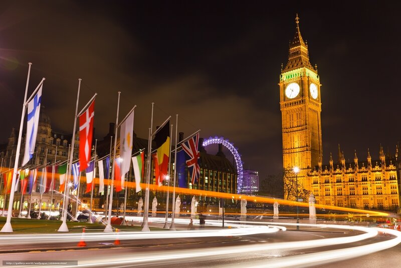 Big Ben at night with flags