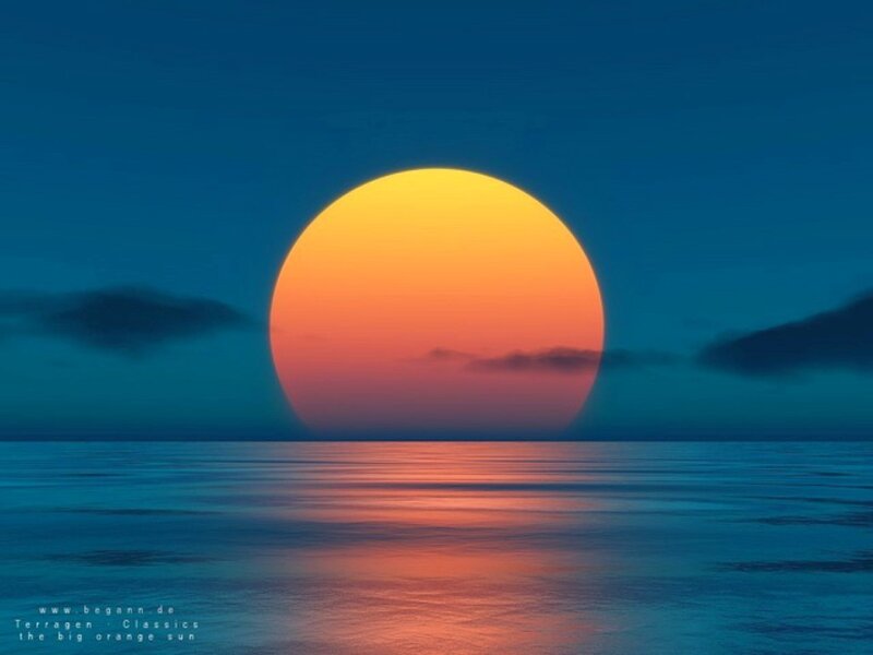 Big orange sun over ocean