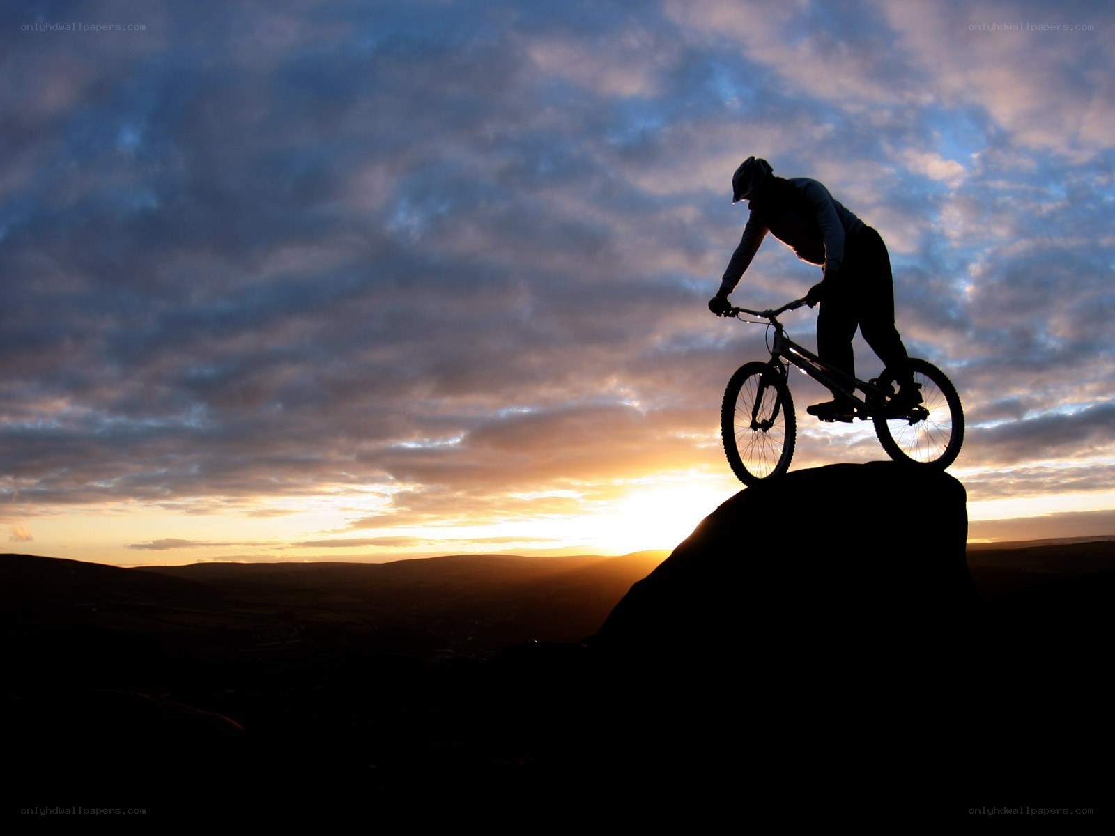 Biker at sunset silhouette