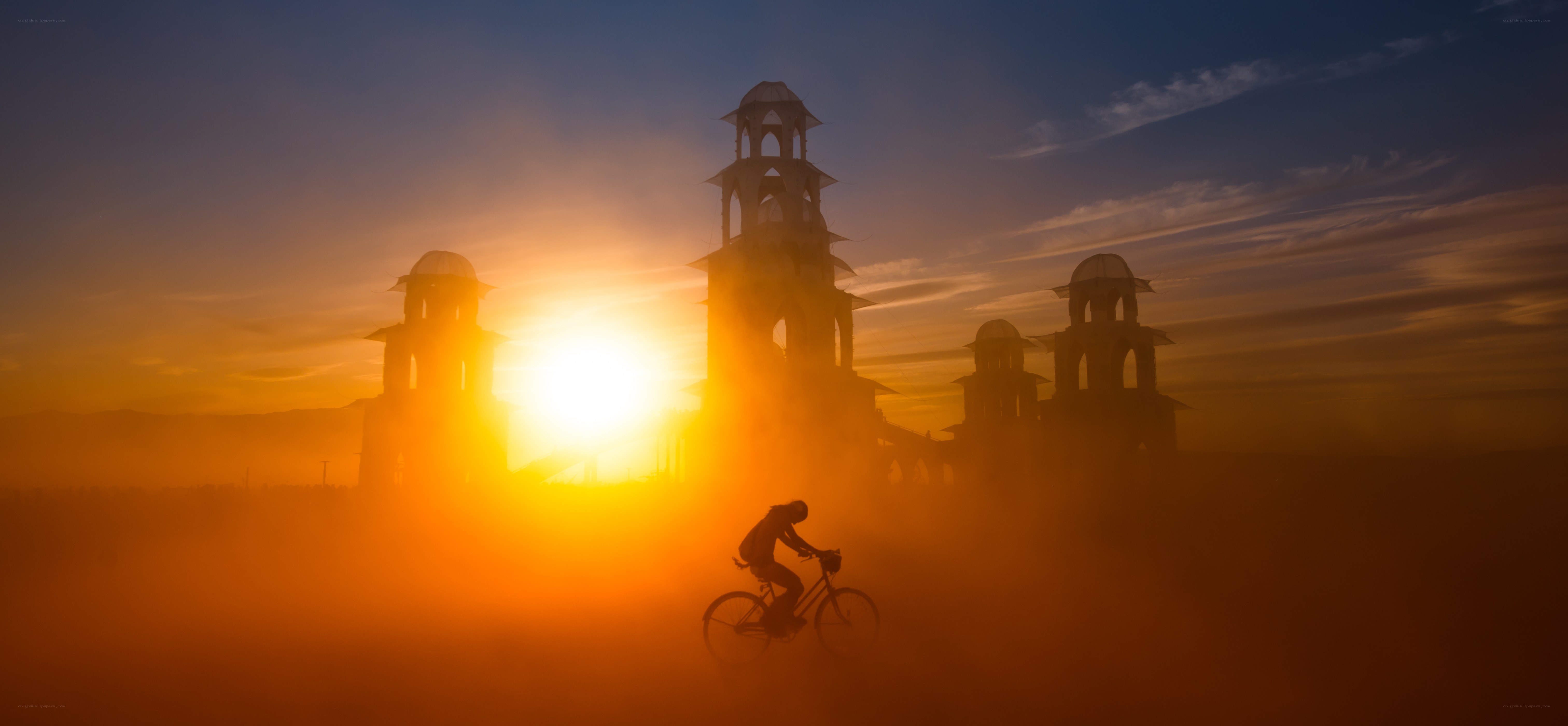 Biker at sunset with towers