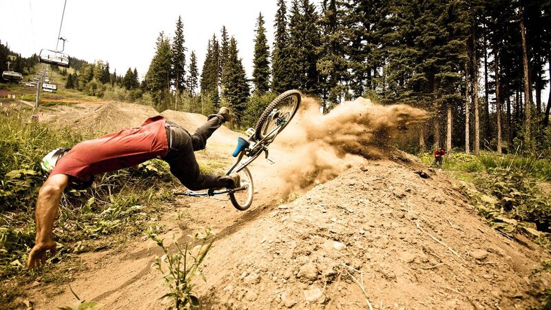 Biker falls on dirt trail