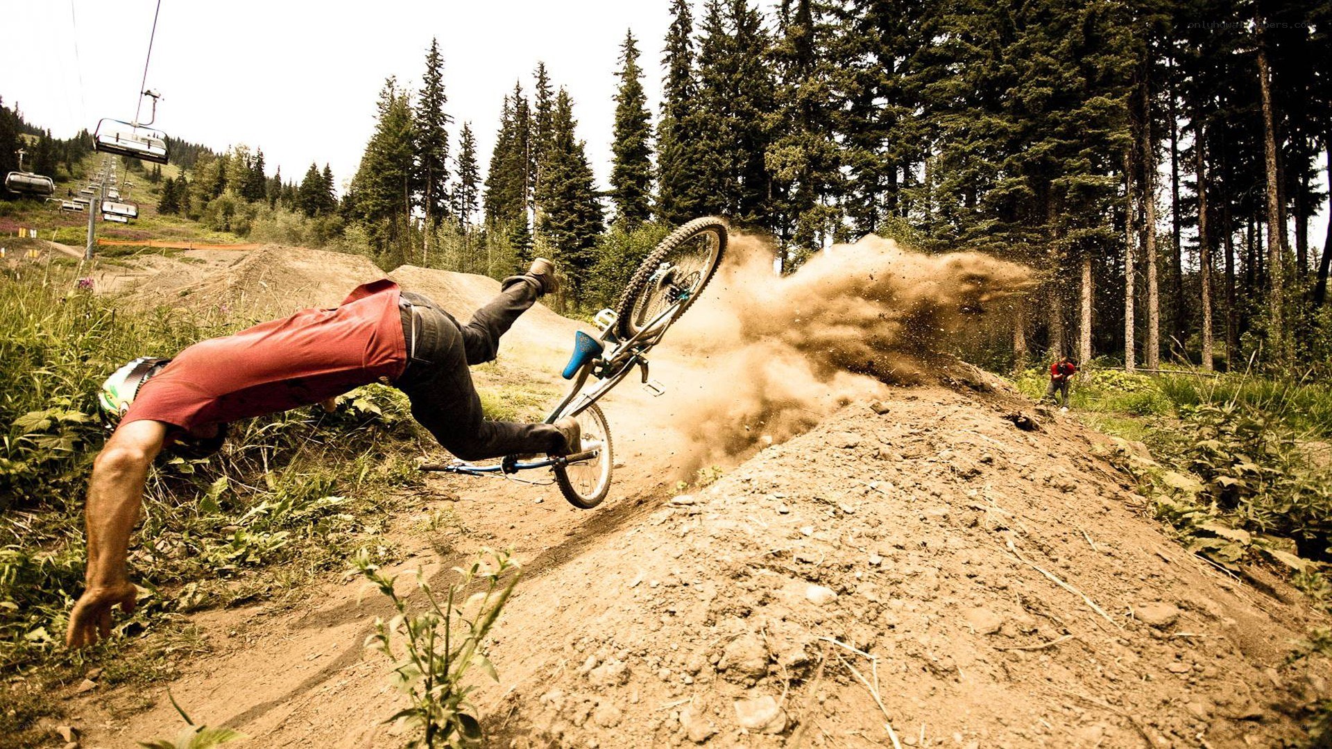 Biker falls on dirt trail