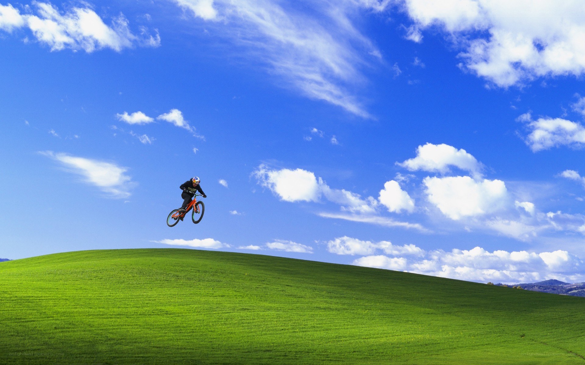 Biker jumping over a hill