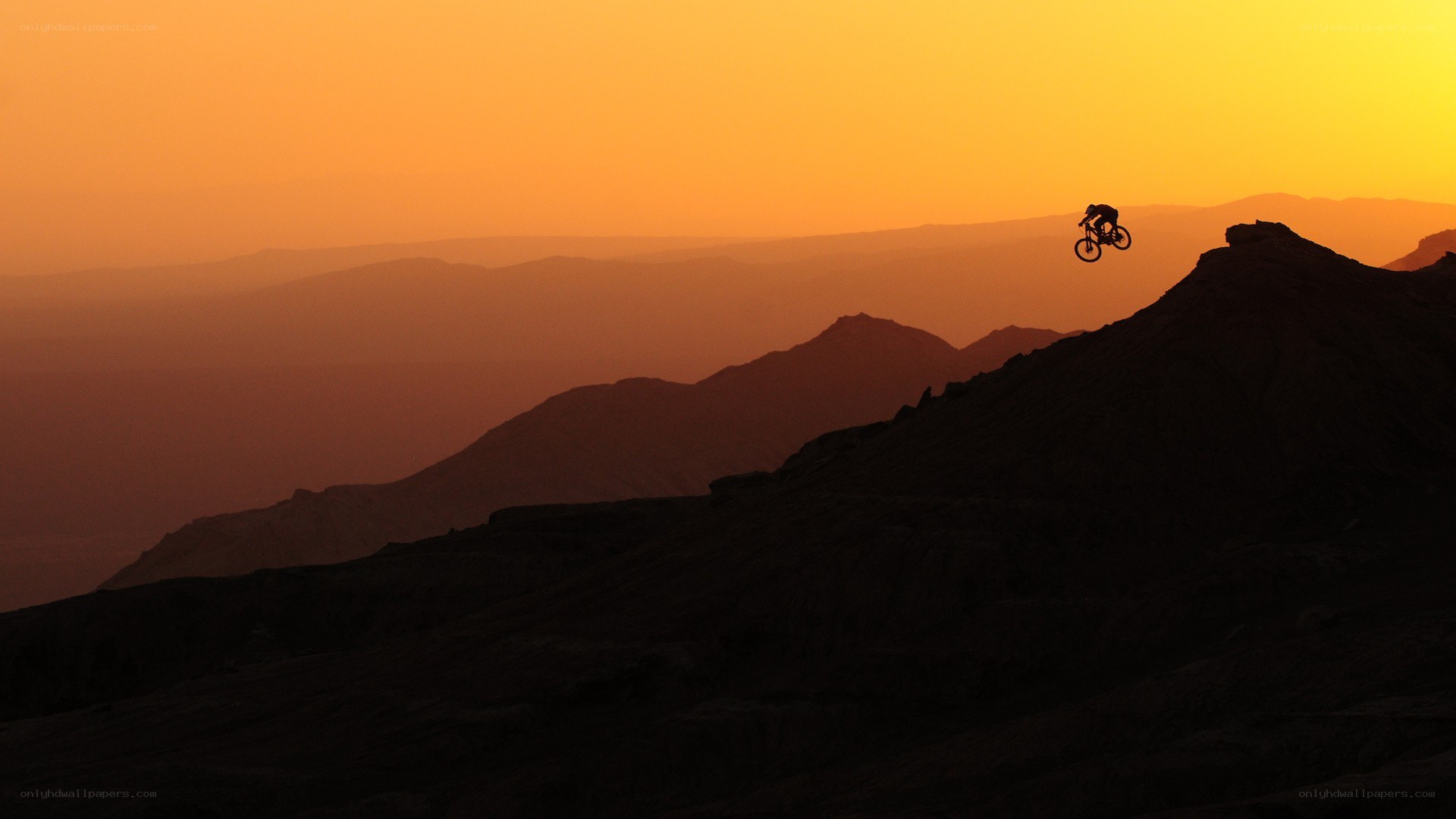 Biker silhouetted at sunset