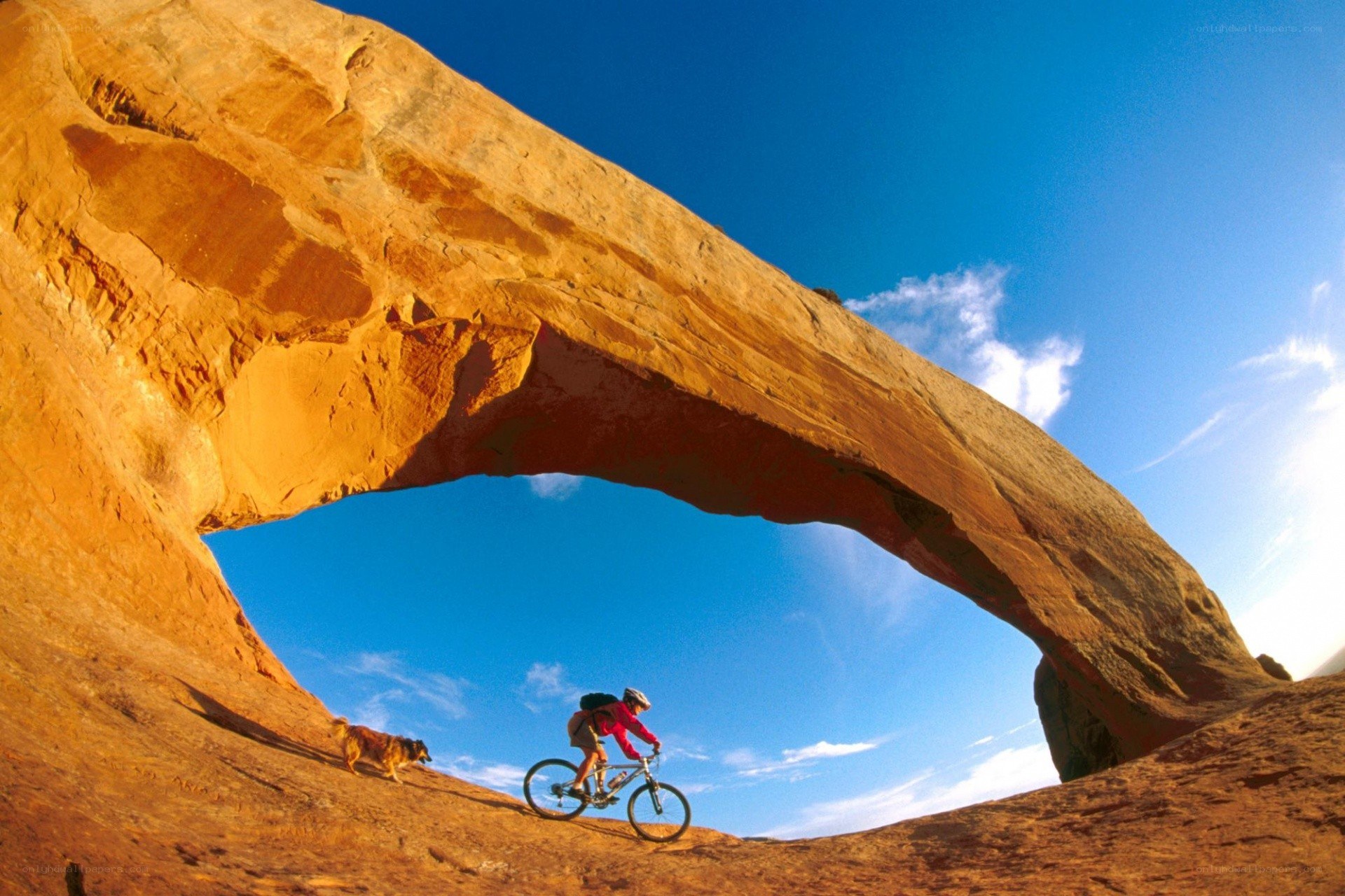 Biker under a natural arch
