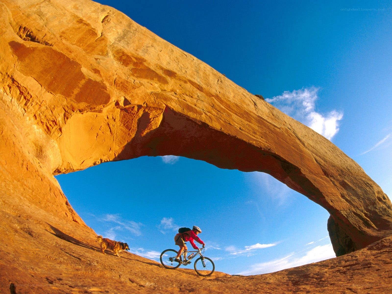Biker under a natural arch