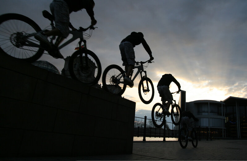 Bikers on a ramp at dusk