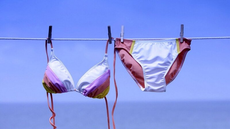 Bikini on clothesline against blue sky