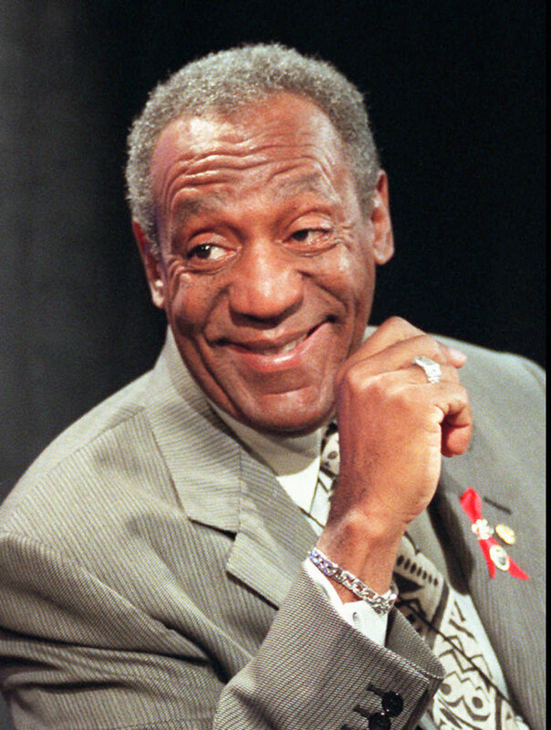 Bill Cosby smiling in a suit