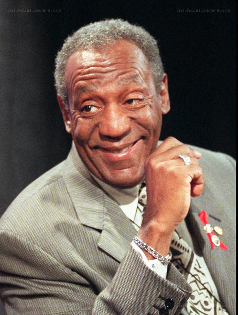 Bill Cosby smiling in a suit
