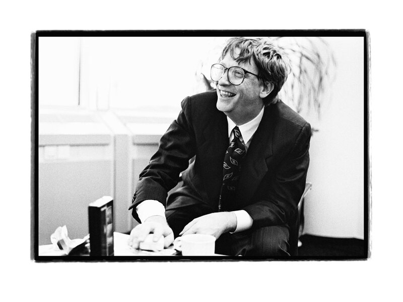 Bill Gates smiling at desk
