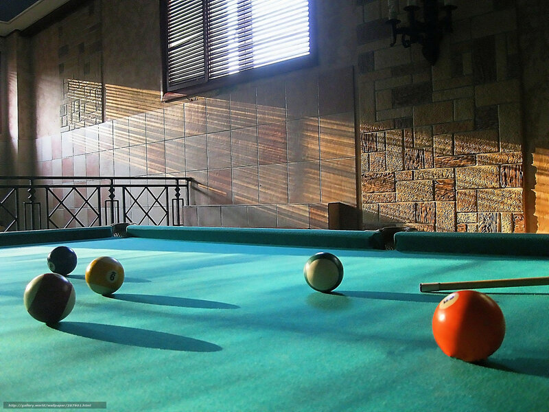 Billiards table in sunlit room