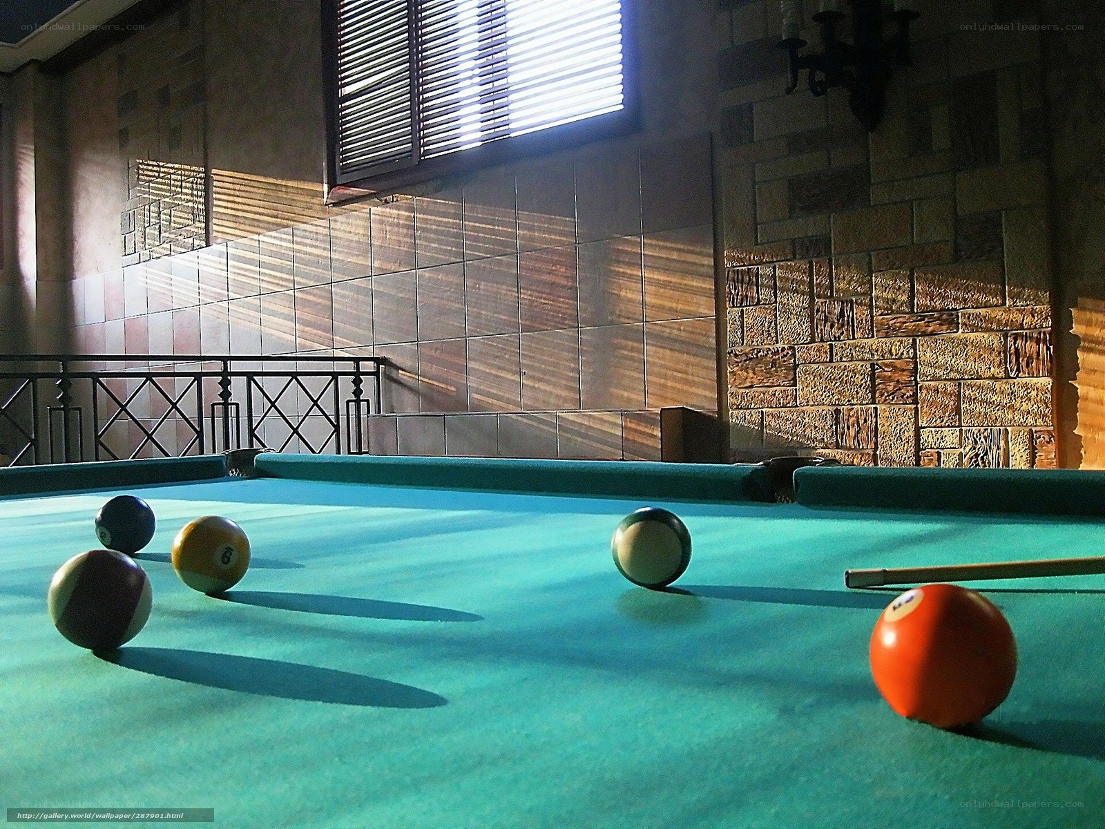 Billiards table in sunlit room