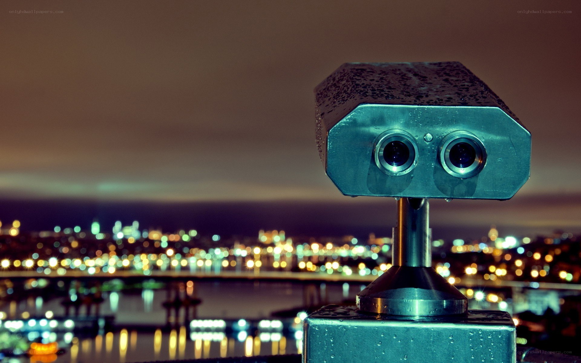 Binoculars overlooking city at night