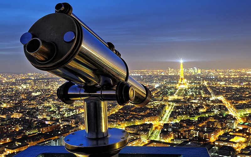 Binoculars overlooking Paris at night