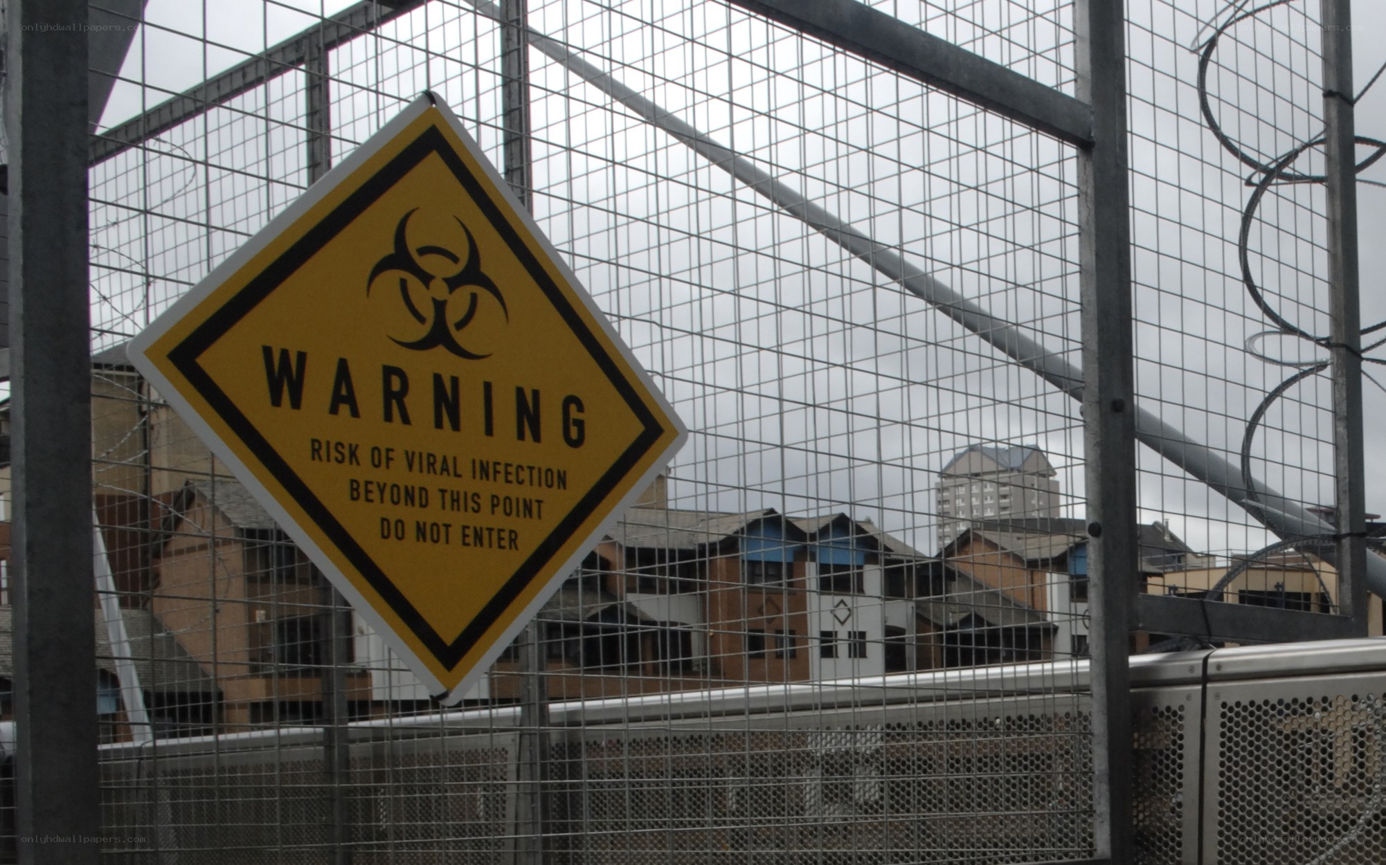 Biohazard warning sign on fence