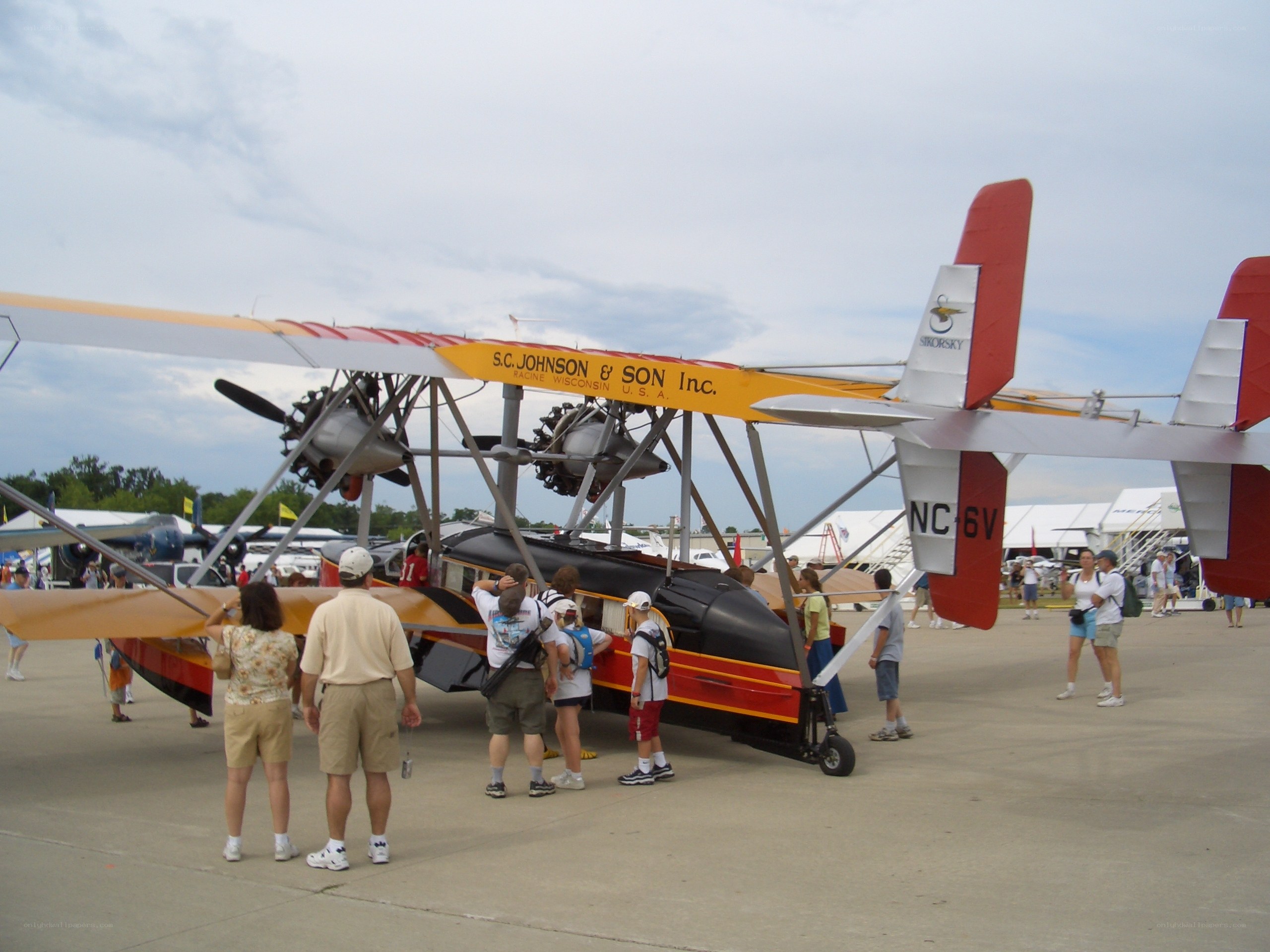 Biplane at airshow with spectators