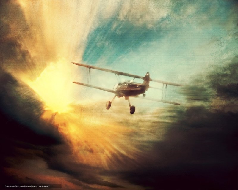 Biplane flying at sunset