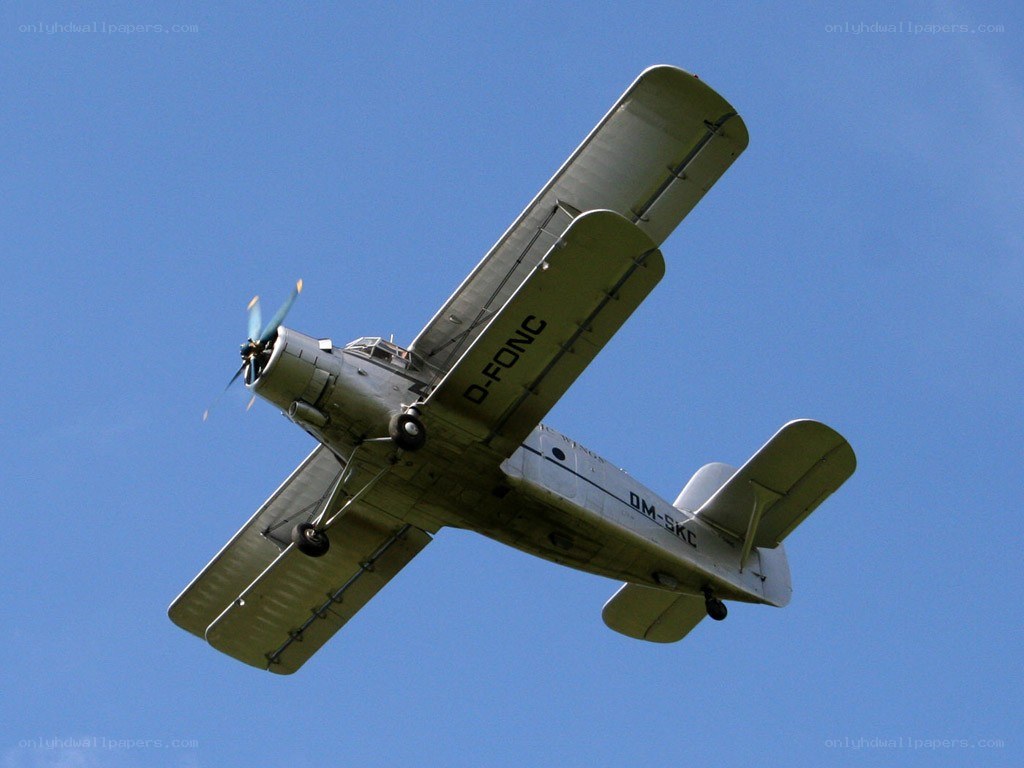 biplane flying in blue sky