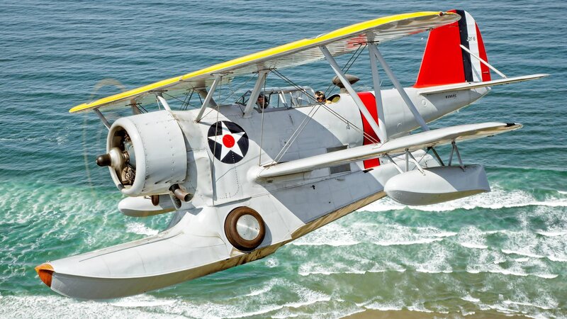 Biplane Flying over Ocean — White