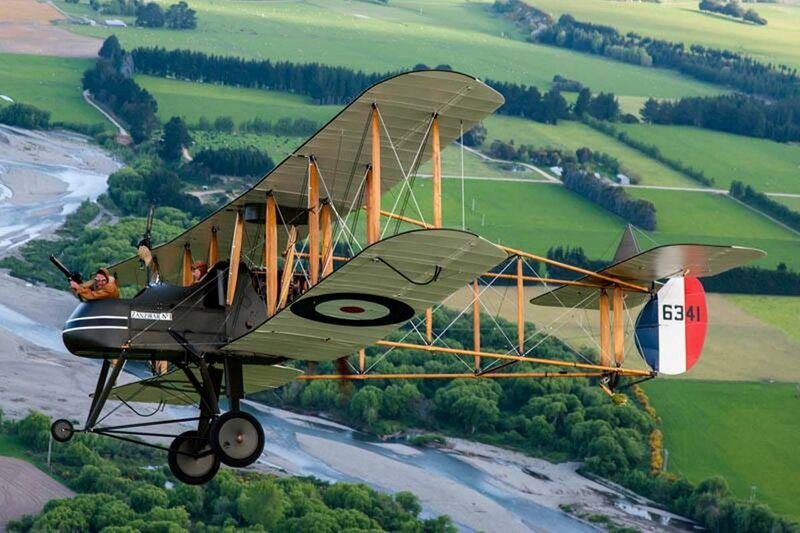 Biplane Flying over River — Green