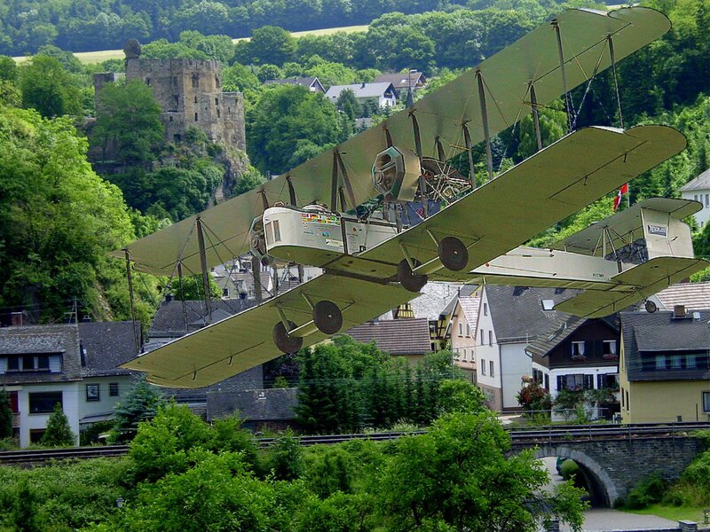 Biplane Flying over Town