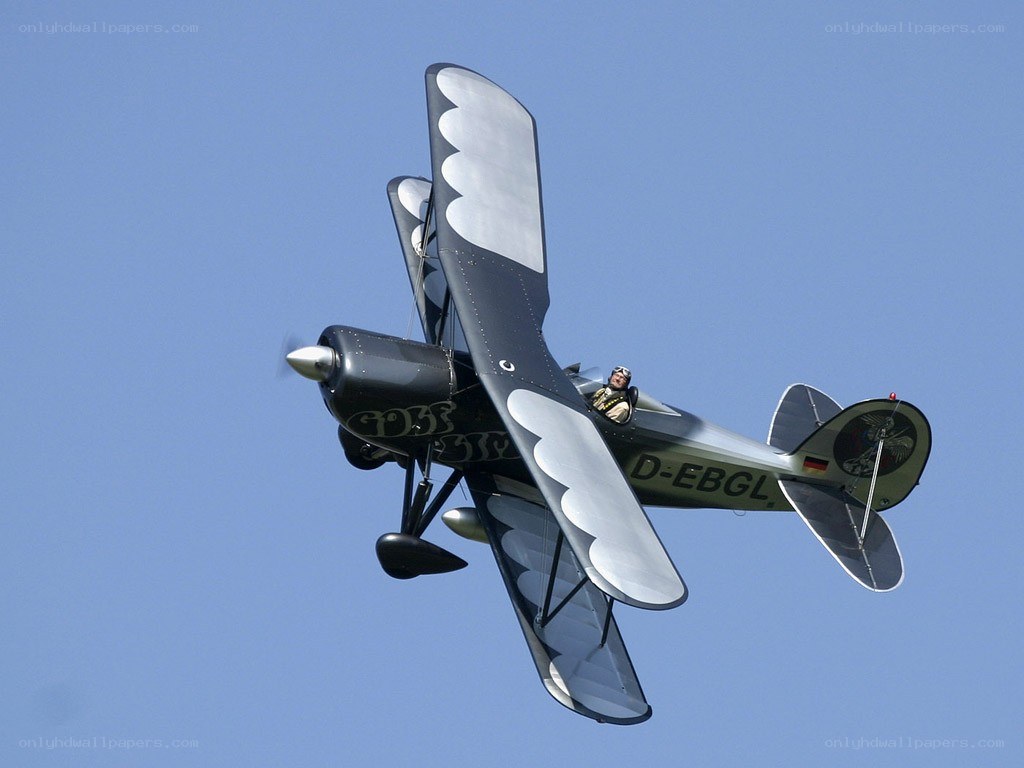 biplane in flight against blue sky