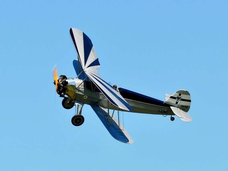Biplane in Flight — Blue, Dynamic, Afternoon
