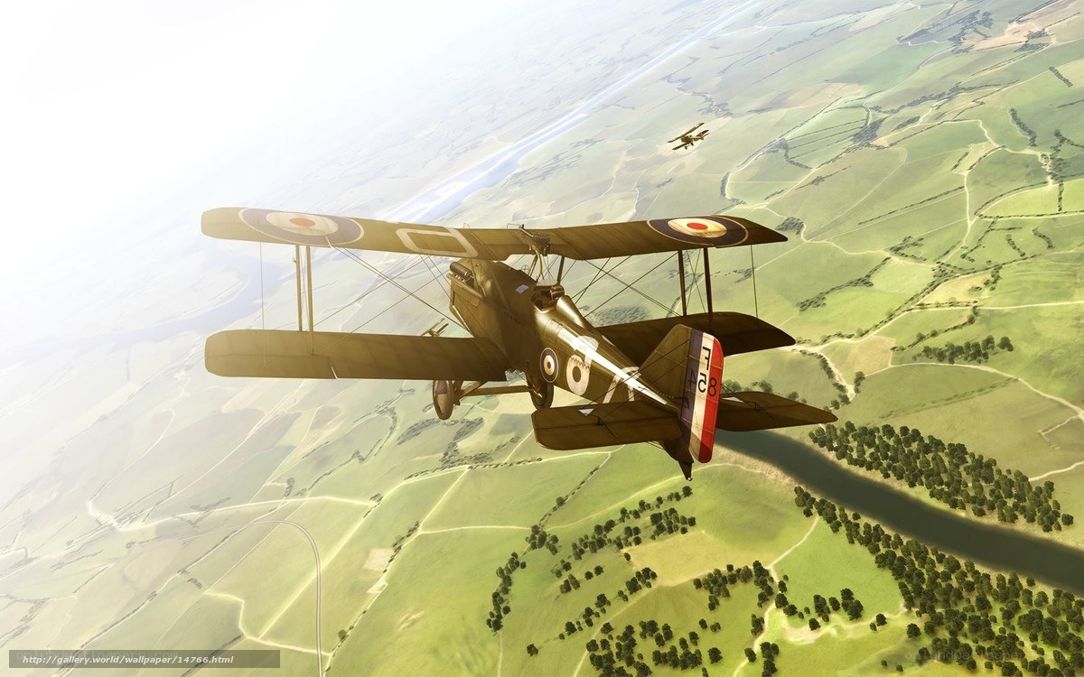 Biplane in flight over countryside