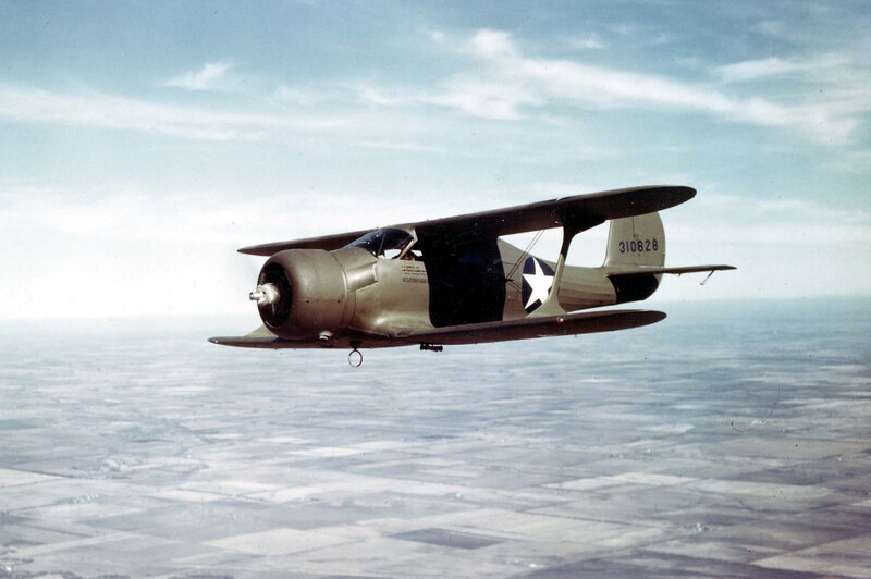 Biplane in flight over landscape