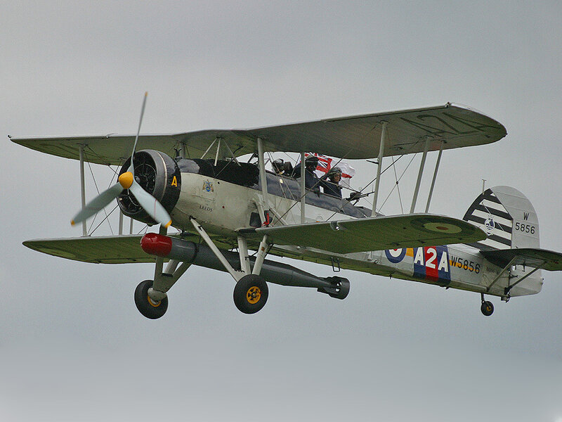 Biplane in flight with crew