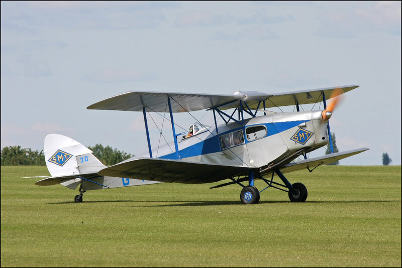 Biplane on Grass Field — Green, Calm, Afternoon