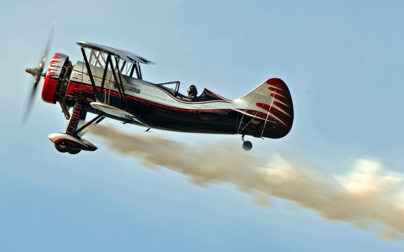 Biplane Performing Aerobatics — Blue