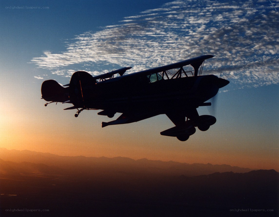 Biplane silhouette at sunset
