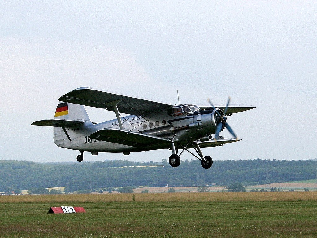 biplane taking off from airfield