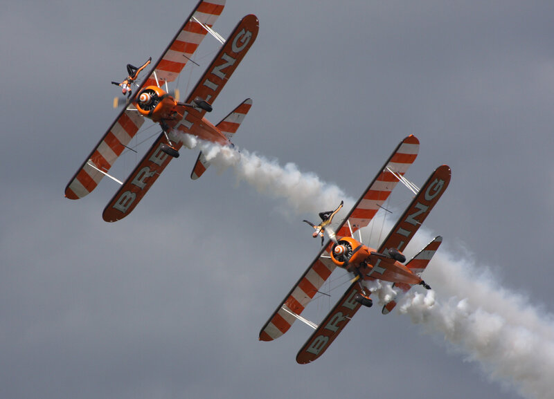 Biplanes Performing Aerobatics — Orange