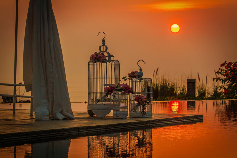 Birdcages by Pool at Sunset