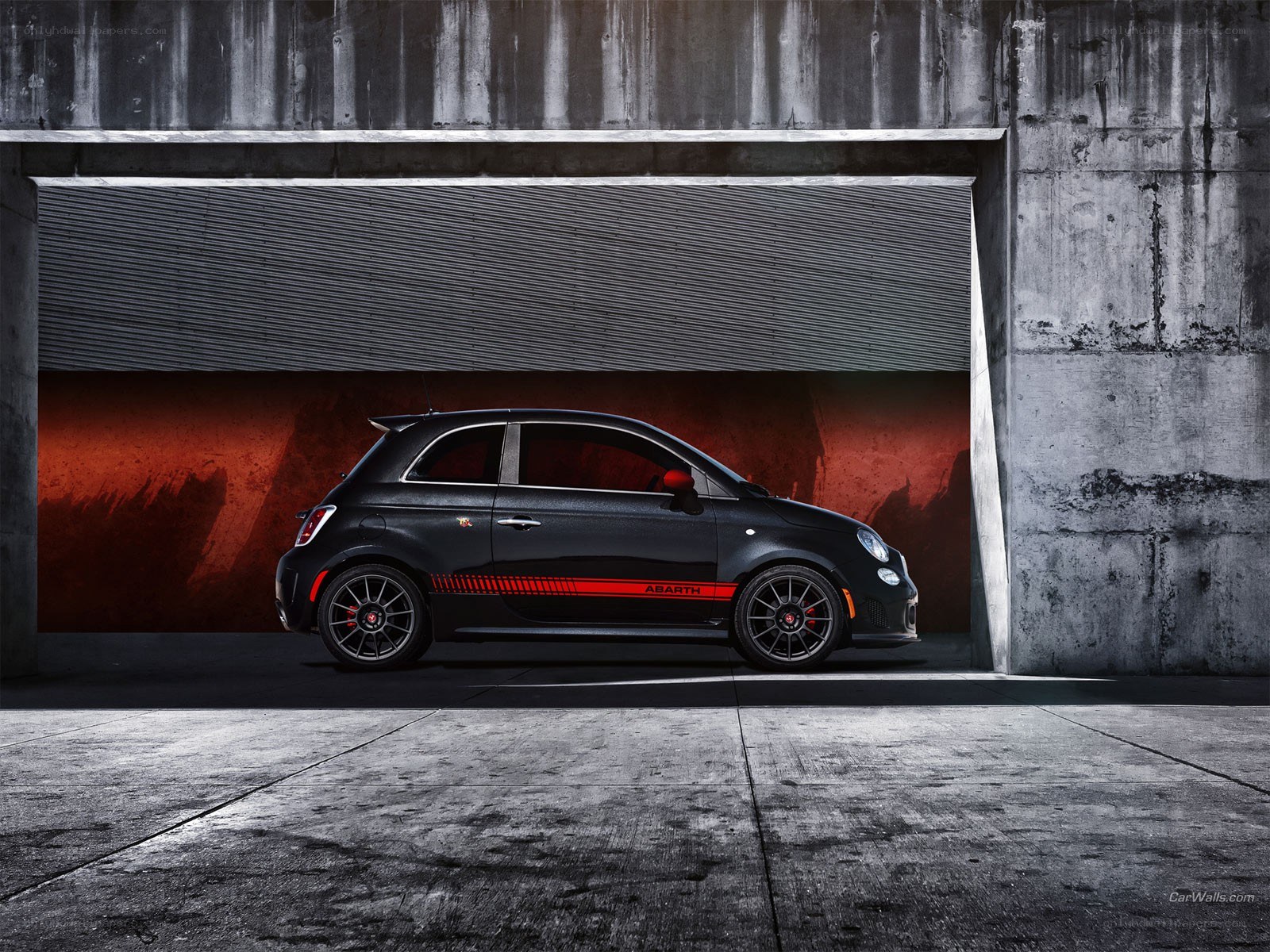 Black Abarth car in garage