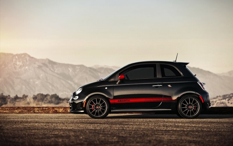 Black Abarth car on mountain road