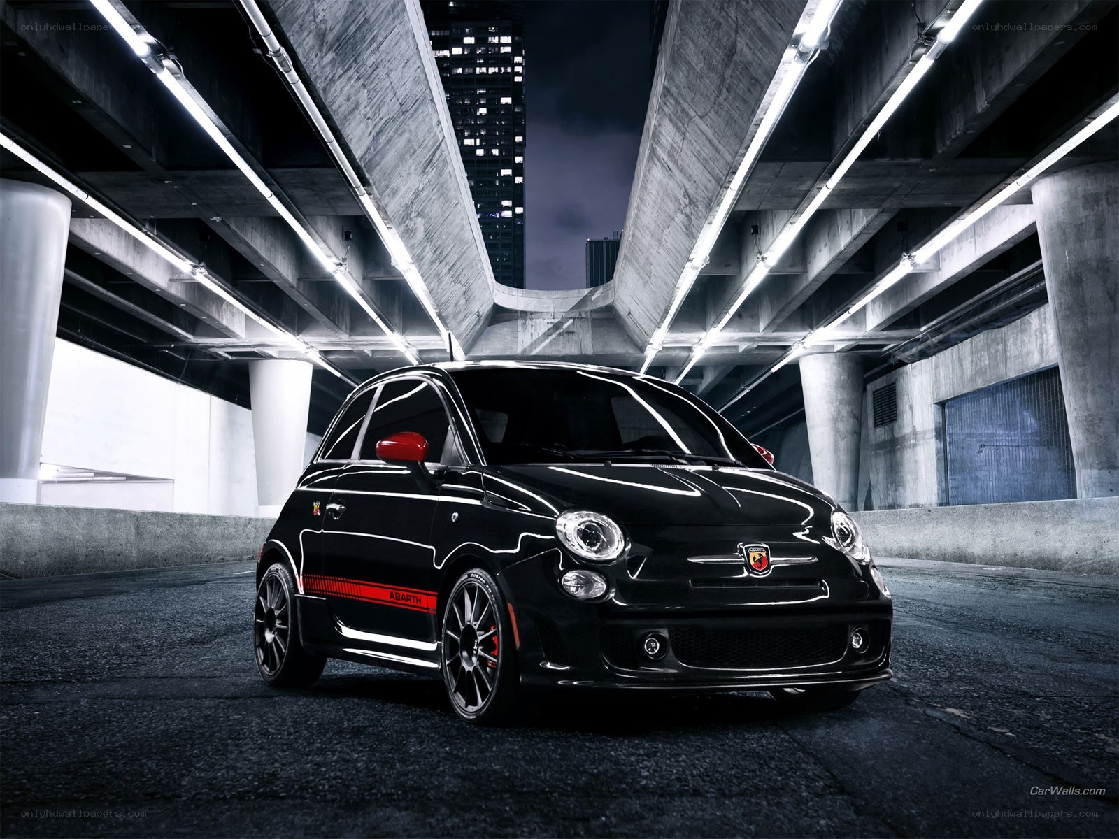 Black Abarth car under bridge